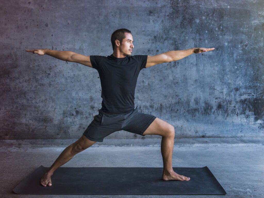 athletic man performing yoga for strength athletes