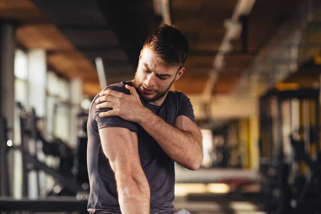 male athlete with shoulder pain, is your workout hurting you?