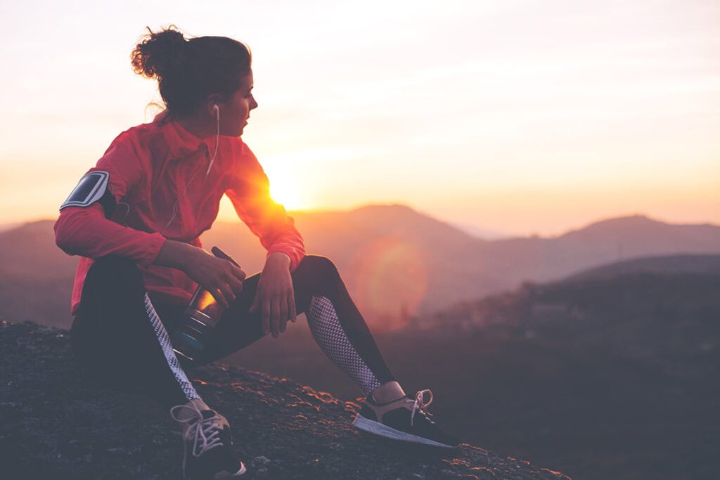 female athlete enjoying sobriety in the mountains