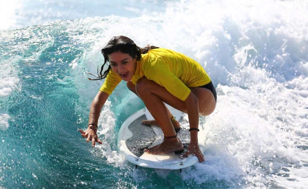 female surfer using surf timing and takeoff