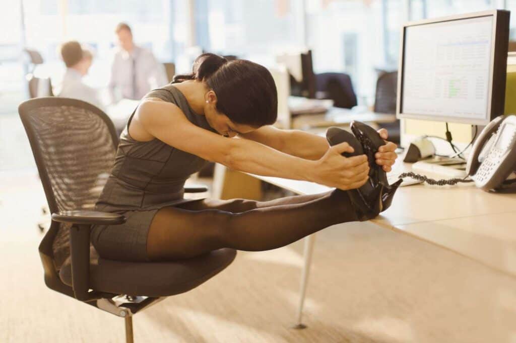 woman performing desk exercises and stretching